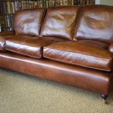 The Loose Back Cushion Three-Seater Lansdown Sofa in Leather with Turned Legs & Castors